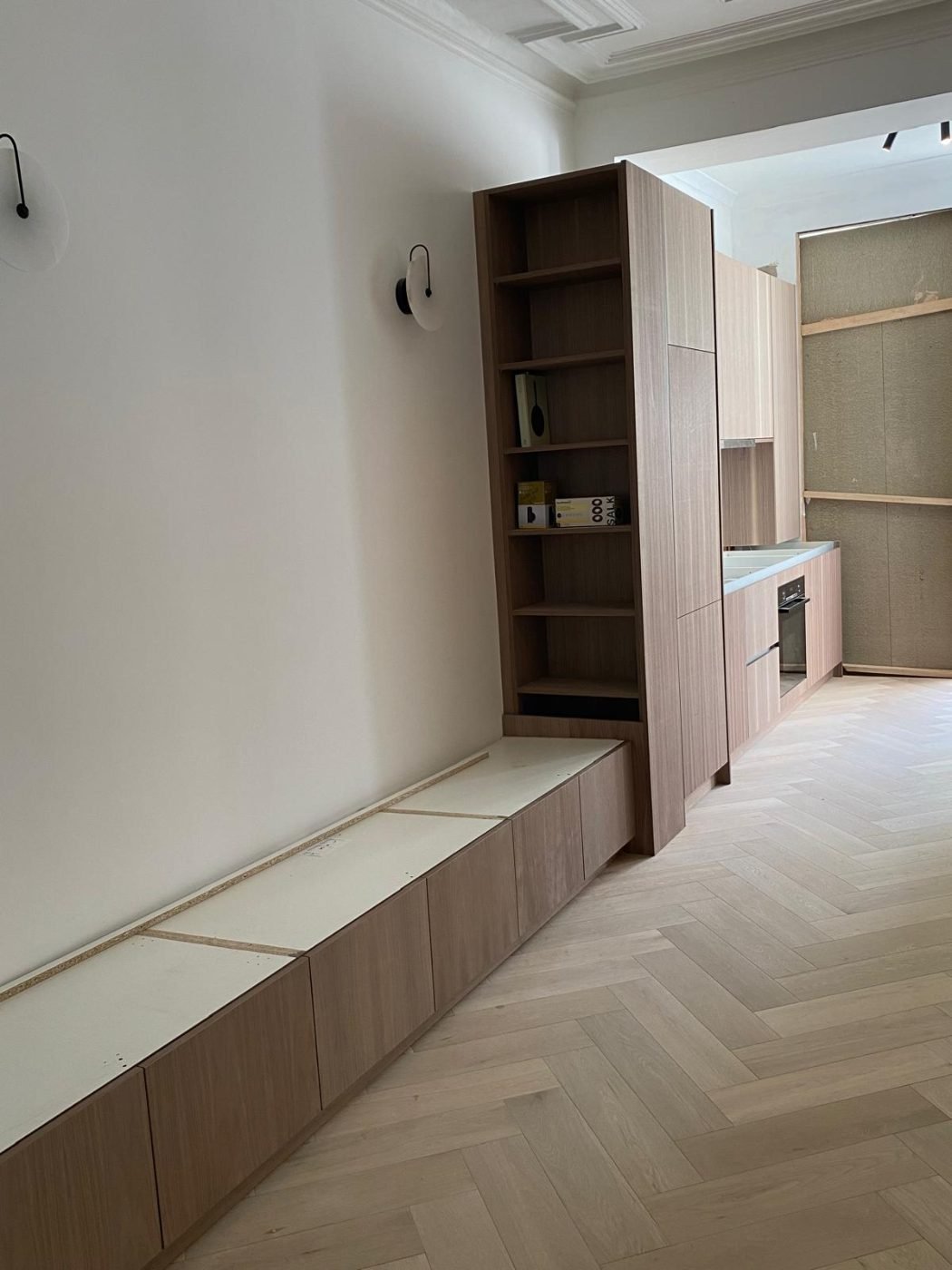 Bespoke walnut units with a built-in window seat by Kulwant Carpentry