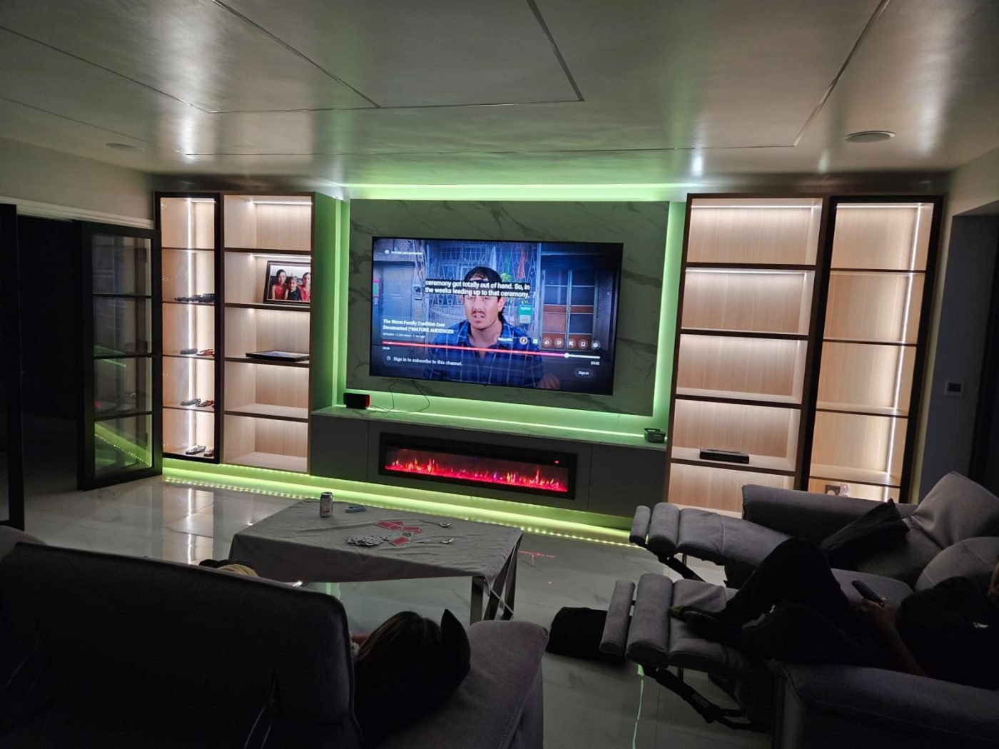 Media wall with LED lighting and fireplace by Kulwant Carpentry